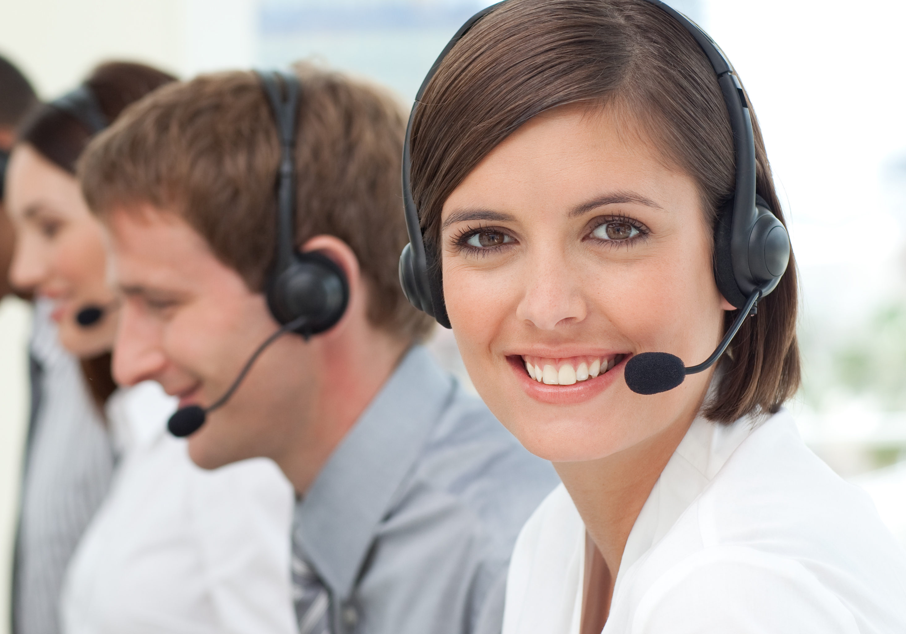 Female customer service agent with headset on in a call center